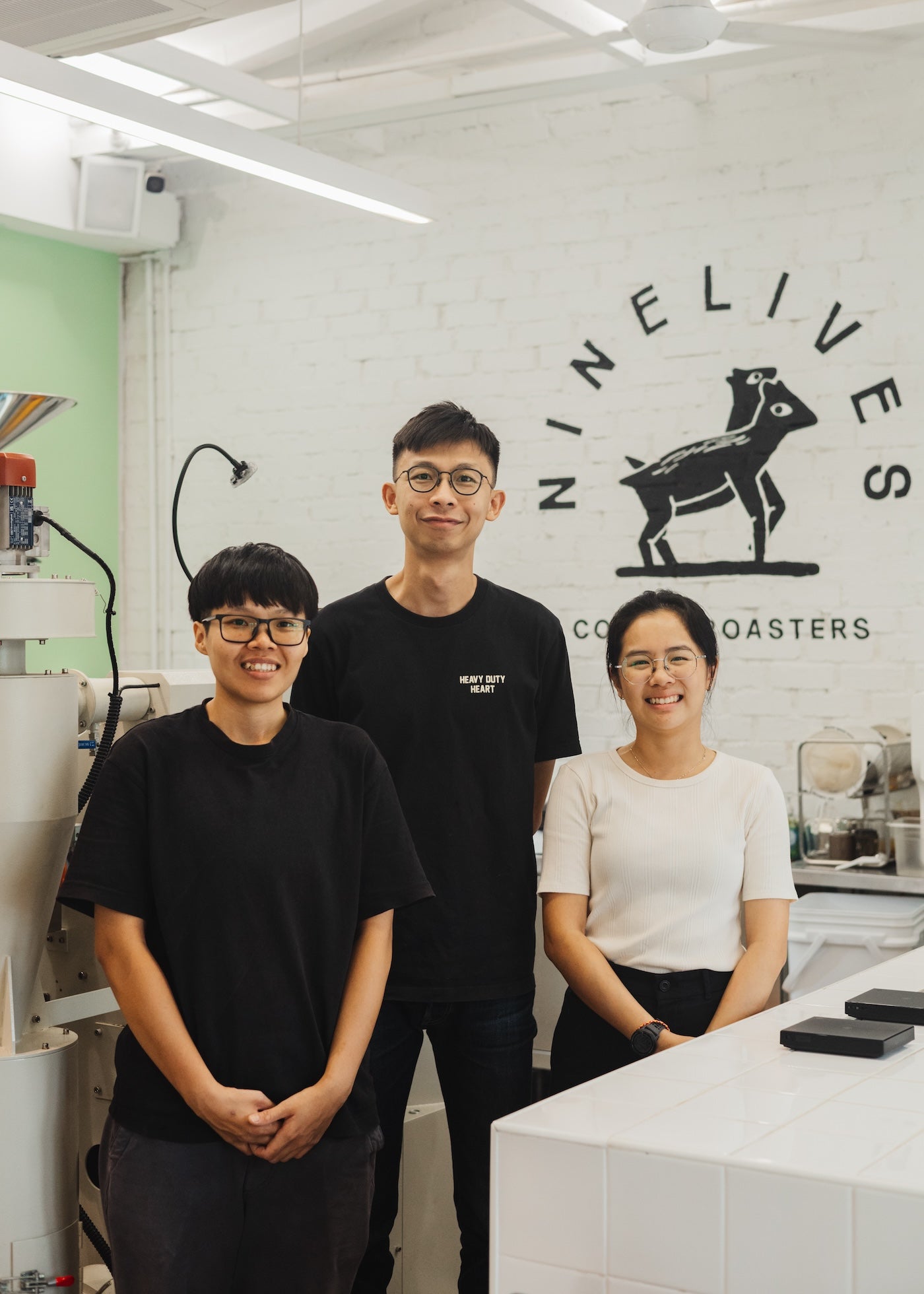 Professional barista and coffee roasters posing for a group photo in Nine Lives Coffee Roasters Penang